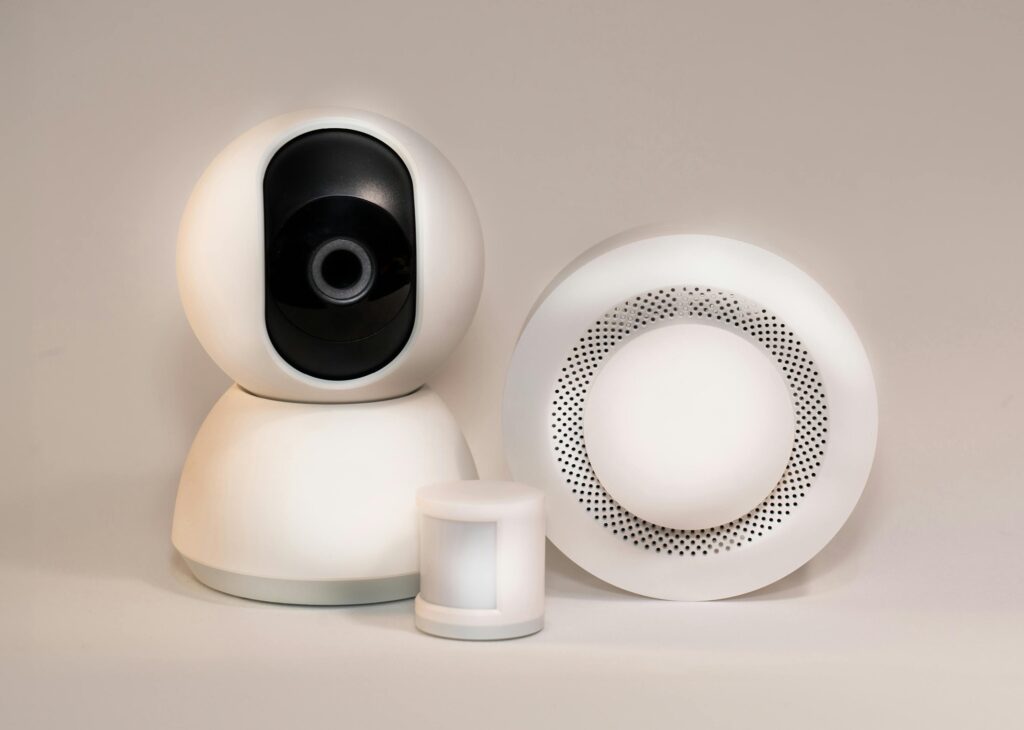 A collection of modern smart home security devices featuring cameras and sensors.